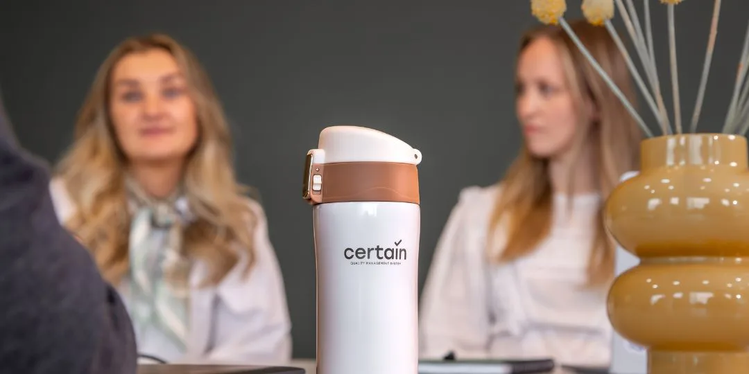 Certain QMS branded mug